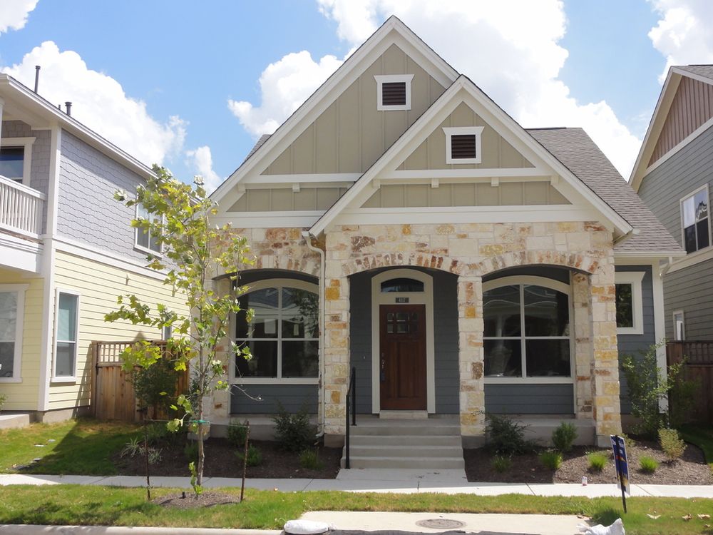 A newly built craftsman-style home with a stone and shingle front